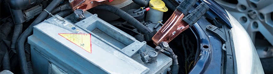 How to prepare your Mazda for the winter season in York, PA at Jack Giambalvo Mazda | Battery jumper cables connected to grey car battery