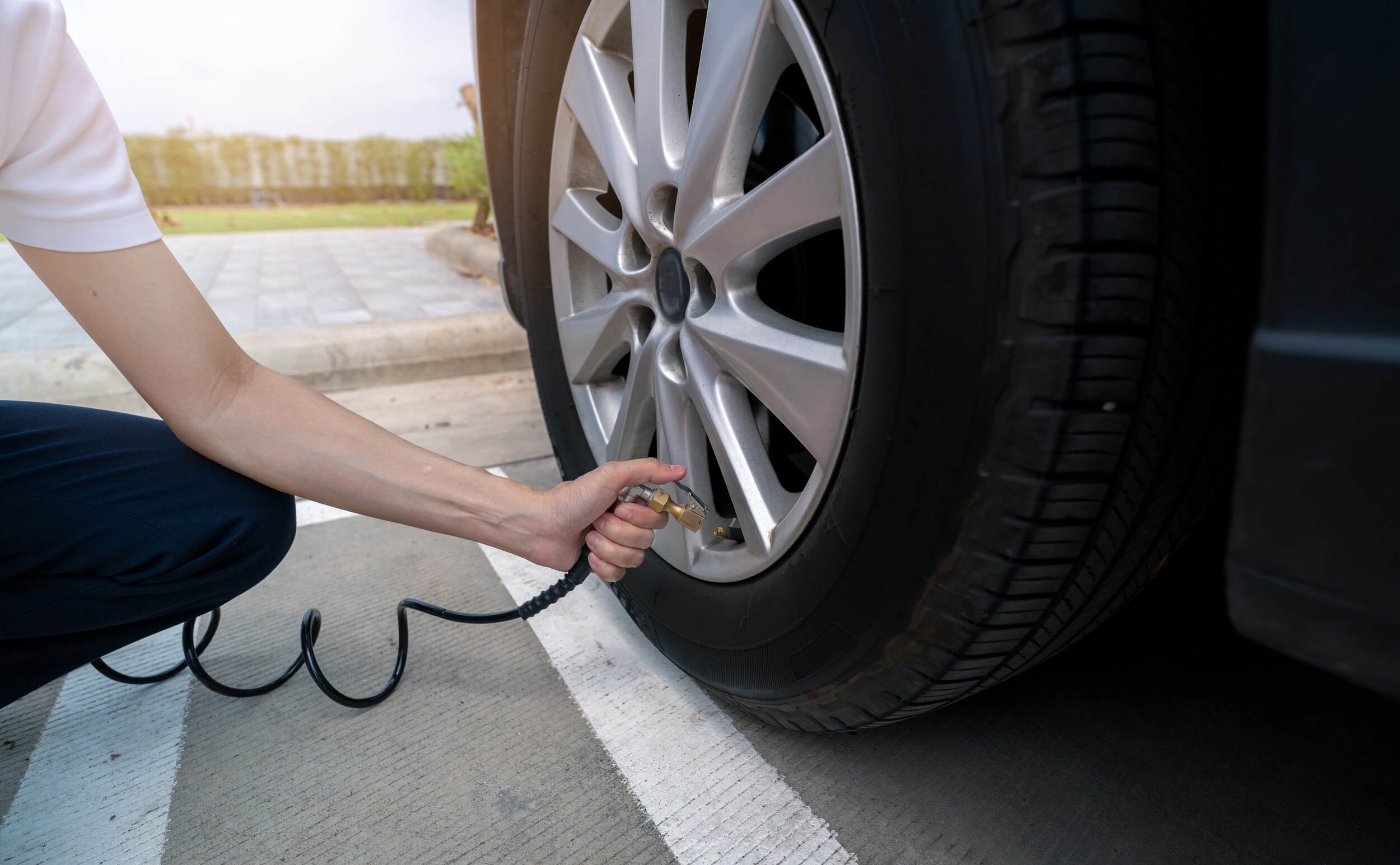Woman filling tire with air | Tire Pressure Information at Jack Giambalvo Mazda in York, PA