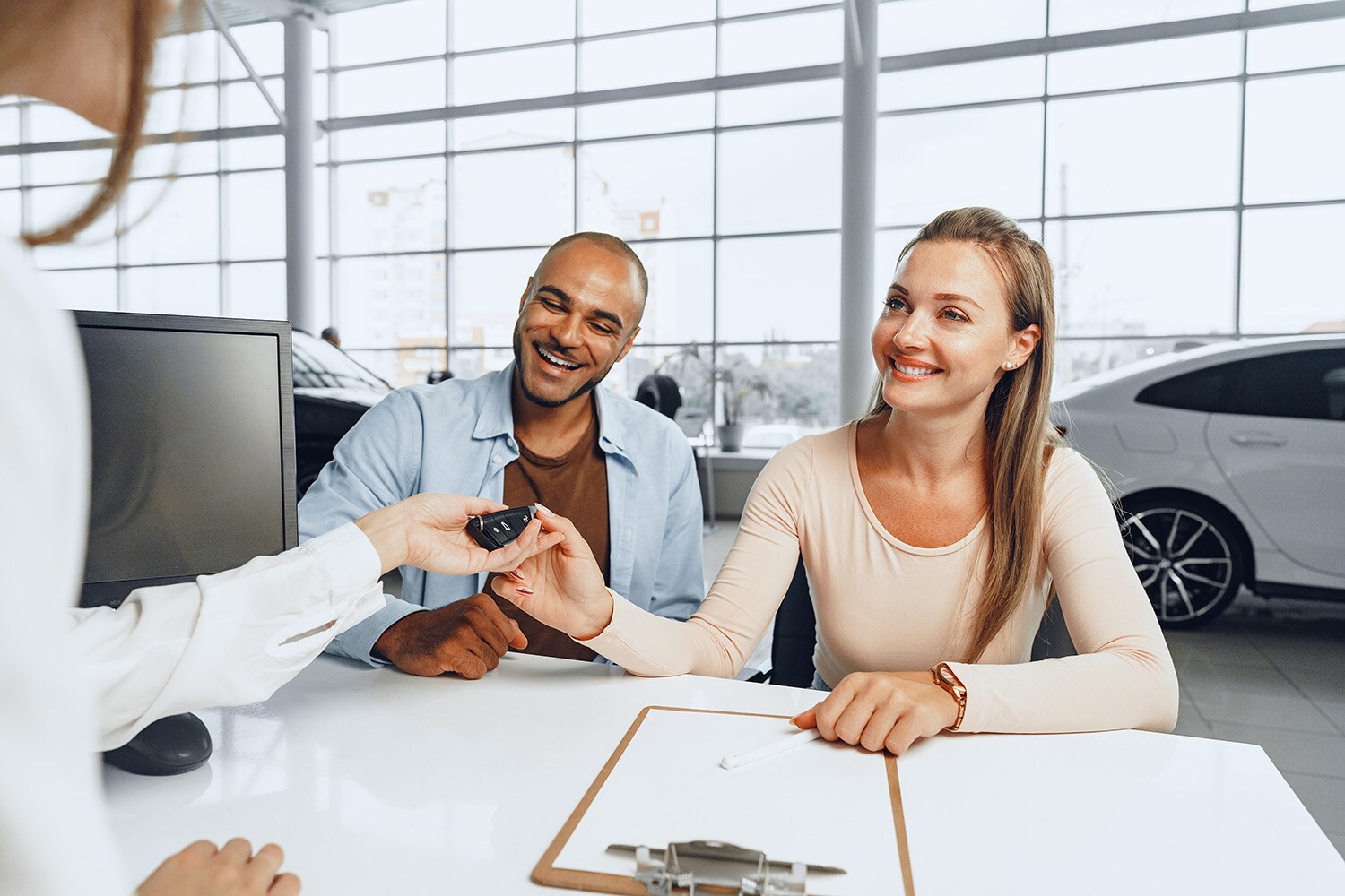 Defining GAP Insurance at Jack Giambalvo Mazda in York, PA | Young couple getting keys from dealership