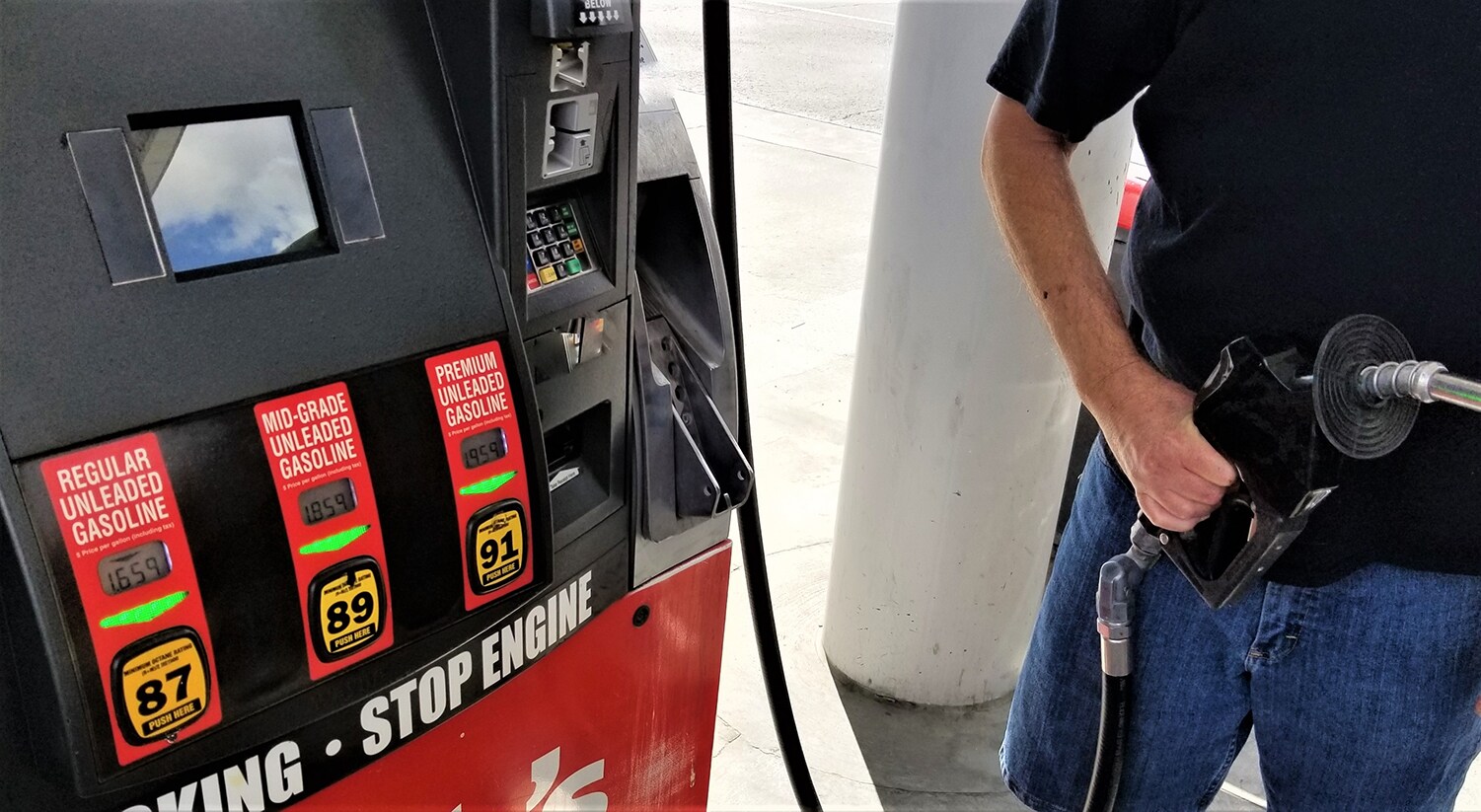Best gas type for my vehicle at Jack Giambalvo Mazda | Man filling up his car at the gas station