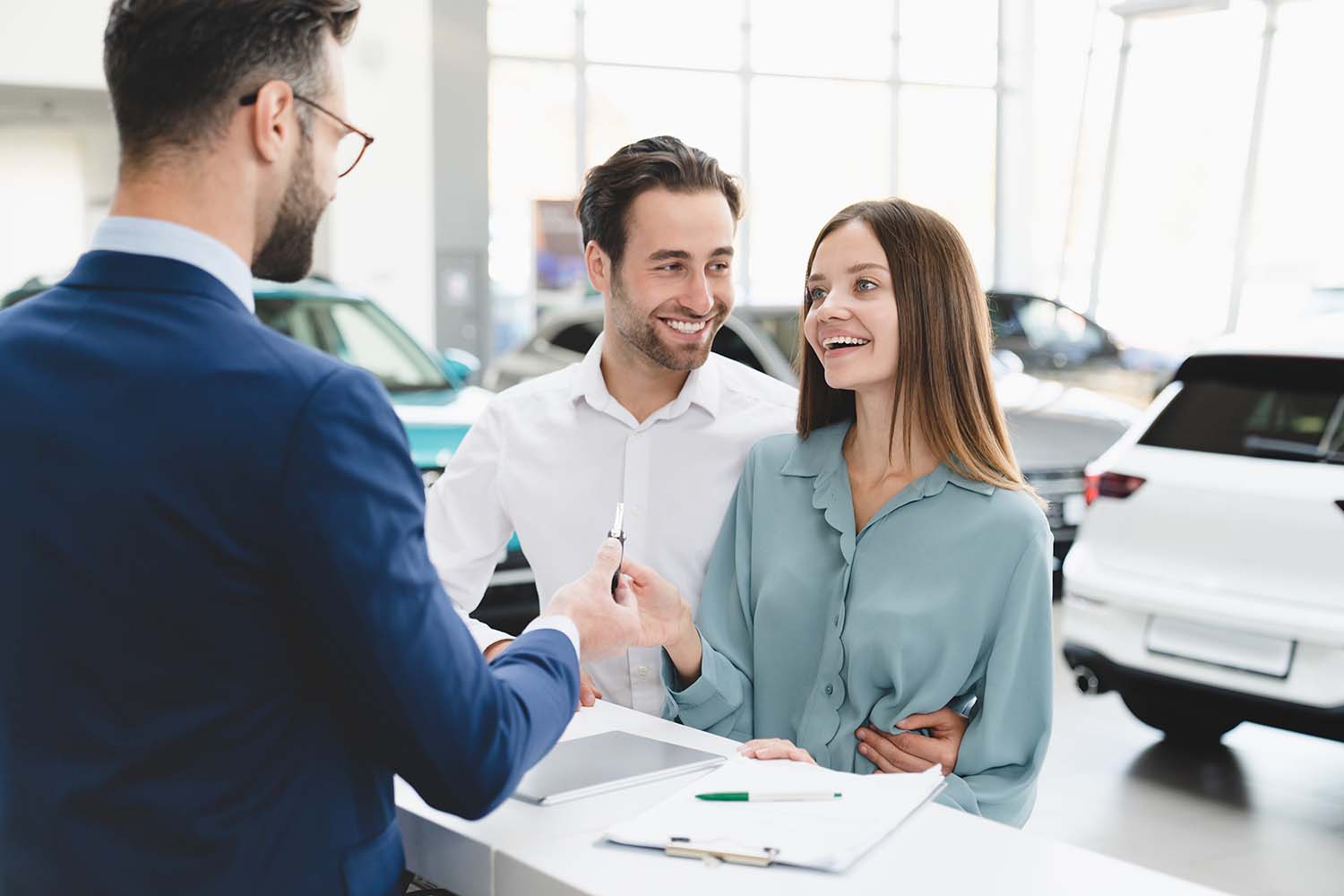 Leasing versus Buying a Mazda at Jack Giambalvo Mazda in York, PA | A couple signing papers for leasing a new vehicle