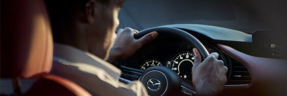 Model Features of the 2021 Mazda3 at Jack Giambalvo Mazda | Close up on driver from backseat
