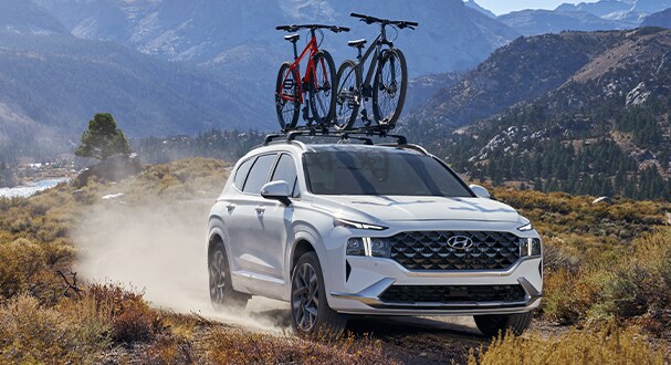Jack Giambalvo Hyundai is a Hyundai Dealership in York near East York, PA | Santa Fe driving on road with bikes on top