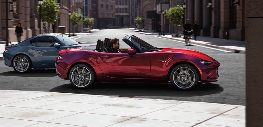 Jack Giambalvo Mazda is a Car Dealership in East York, PA | MX-5 Miata cruising thru small city streets