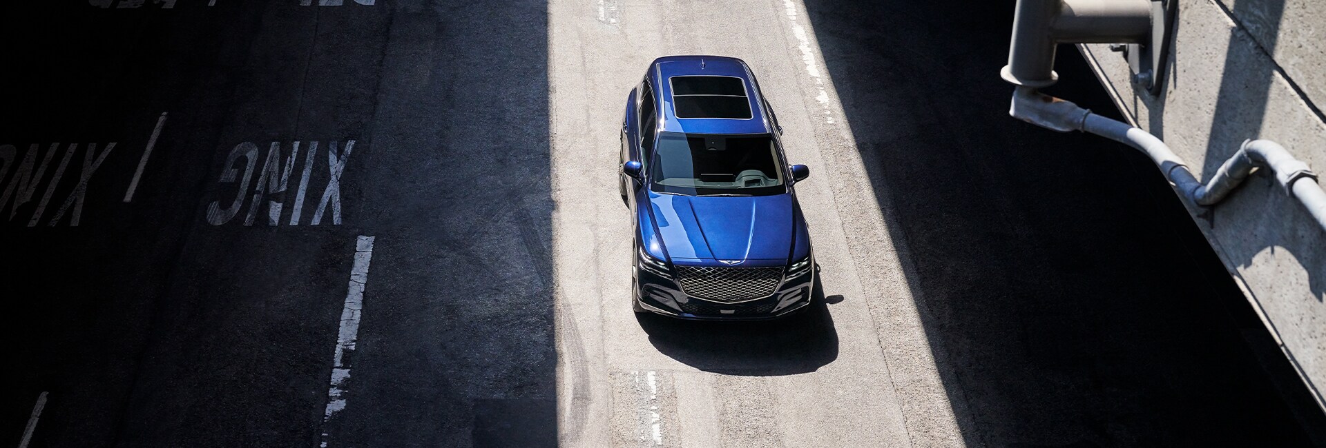 Genesis of York is a Car Dealership near Grantley PA | Blue GV80 in inner city sunlight