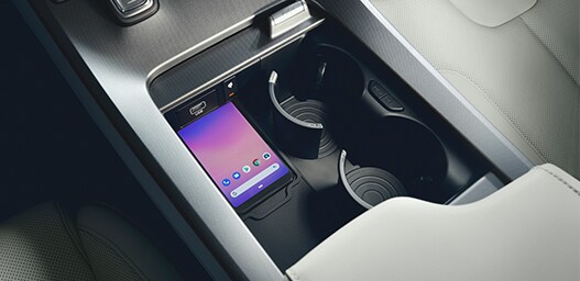 Compare the 2021 Hyundai Palisade vs. the 2021 Toyota Highlander at Jack Giambalvo Hyundai | Center console with two cup holders and place for phone