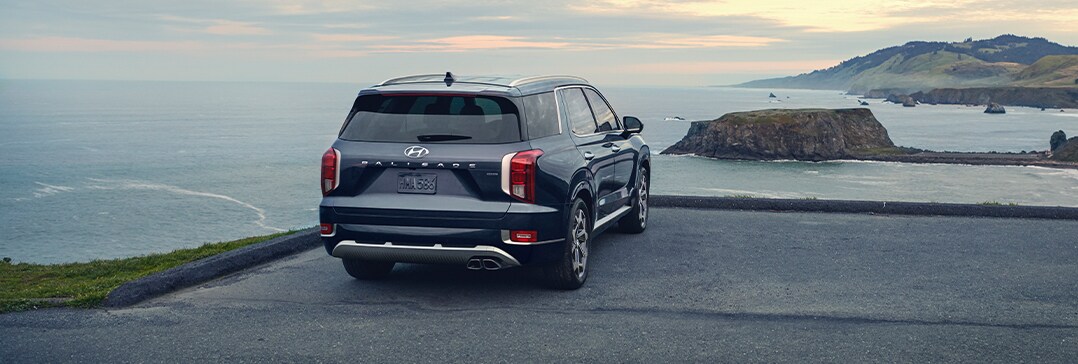 Compare the 2021 Hyundai Palisade vs. the 2021 Toyota Highlander at Jack Giambalvo Hyundai | Palisade sitting on cliff over looking bay