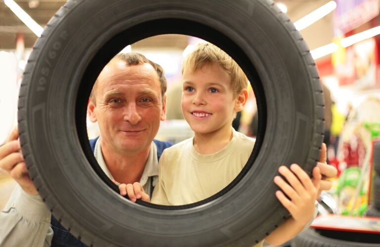 Boy-And-Man-Look-Into-tire_b.jpg