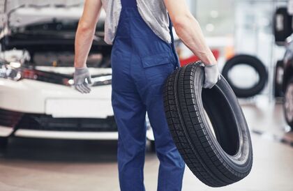 Mechanic-Holding-A-Tire-Tire-A-240391501_b-1.jpg