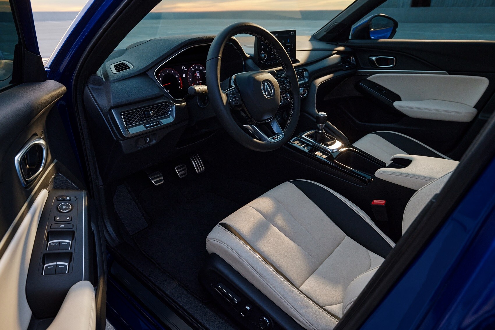 Interior look at Acura Integra from the drivers door to the front seat and dashboard