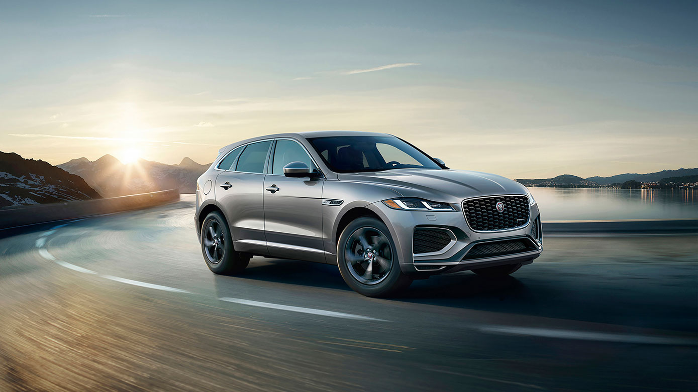 silver Jaguar F-Pace driving along highway