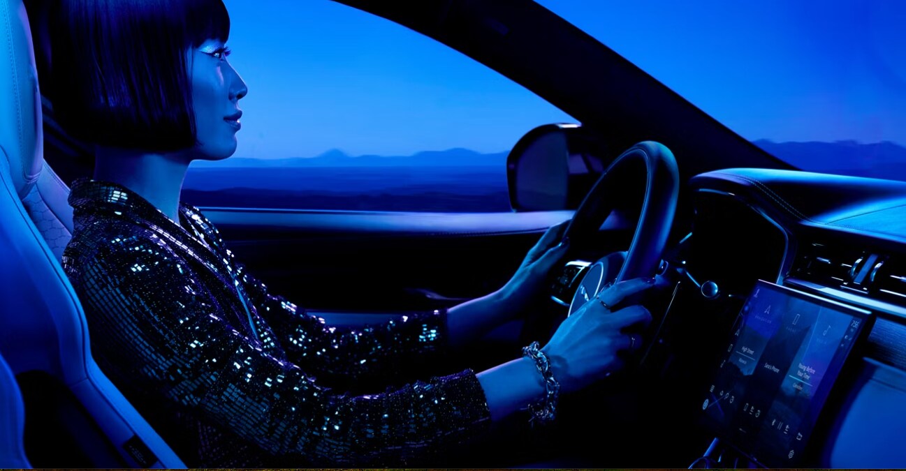 Side profile of a driver behind the wheel of the Jaguar F-PACE Side profile of a driver behind the wheel of the Jaguar F-PACE