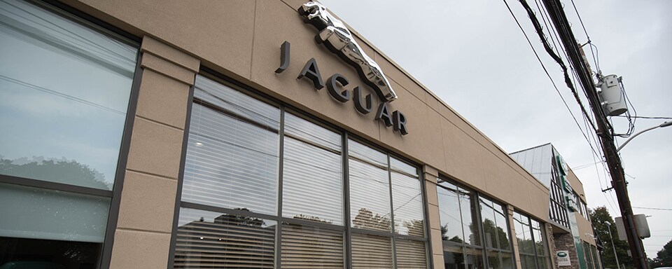 Jaguar Larchmont/New Rochelle Exterior shot during the day of Jaguar Larchmont/New Rochelle, an auto dealership where cars and SUVs are sold.