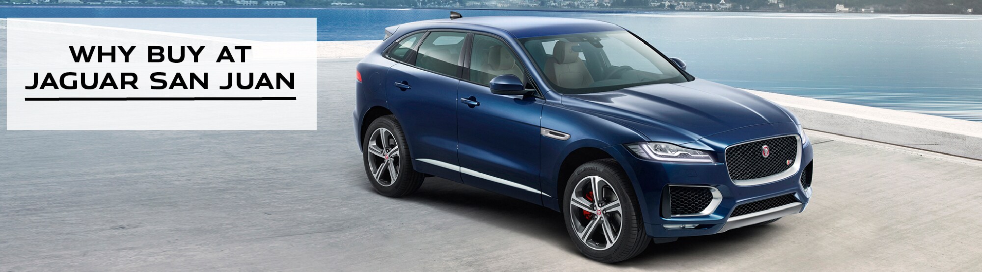 WHY BUY AT JAGUAR SAN JUAN. BLUE JAGUAR F-PACE PARKED NEAR OCEAN.