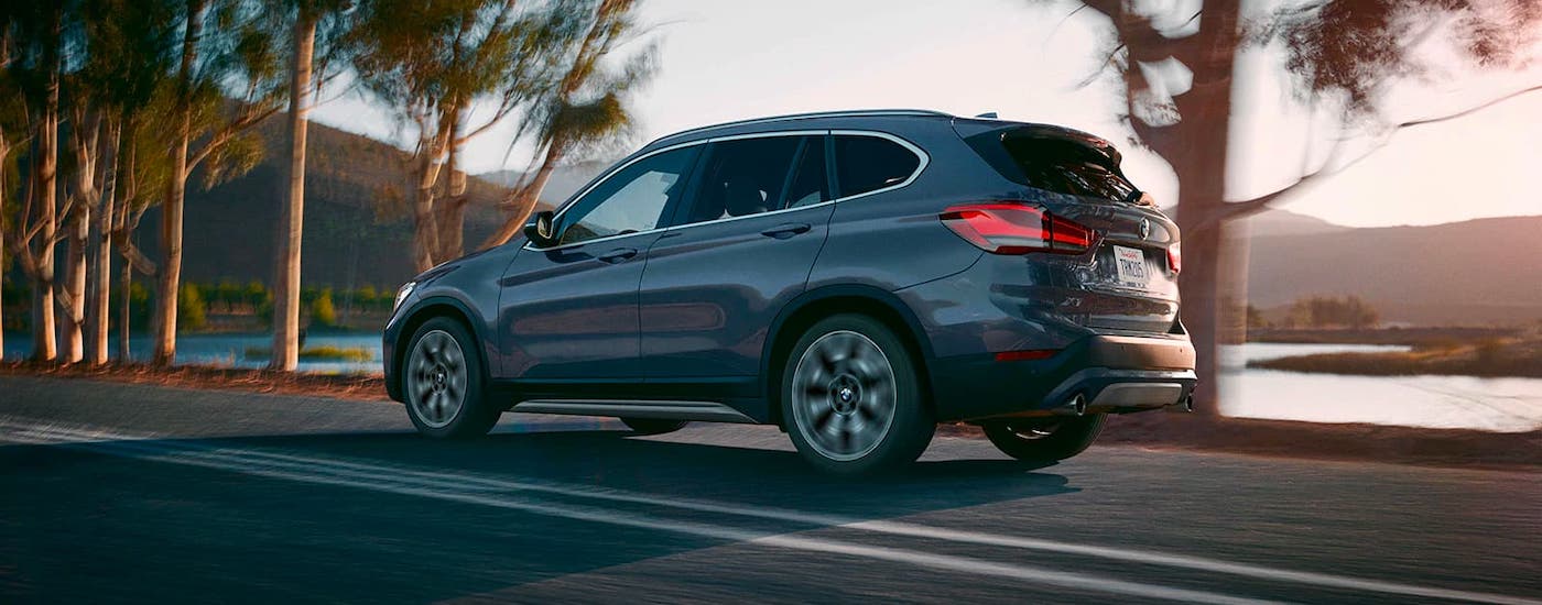 Cincinnati BMW Lease 2021 BMW X1.jpg A gray 2021 BMW X1 is shown from the side driving in front of a lake after getting a Cincinnati BMW lease.