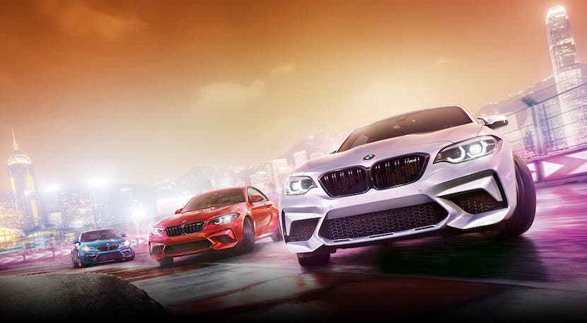 Three 2020 BMW M Series sedans and coupes are are driving on a racetrack against a yellow sky. Three 2020 BMW M Series sedans and coupes are are driving on a racetrack against a yellow sky.