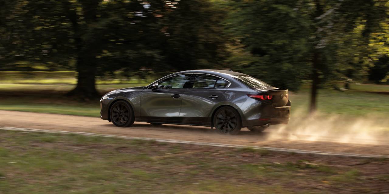 2025 Mazda3 Sedan driving through Cincinnati, highlighting its agile performance.