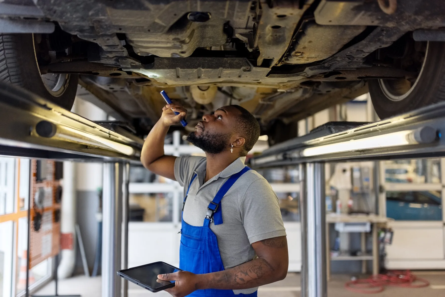 Jeep Recall Underbody Inspection in Las Vegas Jeep technician inspecting a vehicle underbody during recall service in Las Vegas