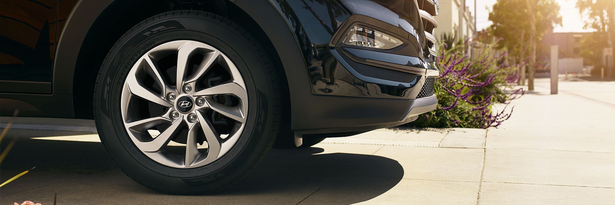 Wheel shot of a hyundai car parked on the sidewalk