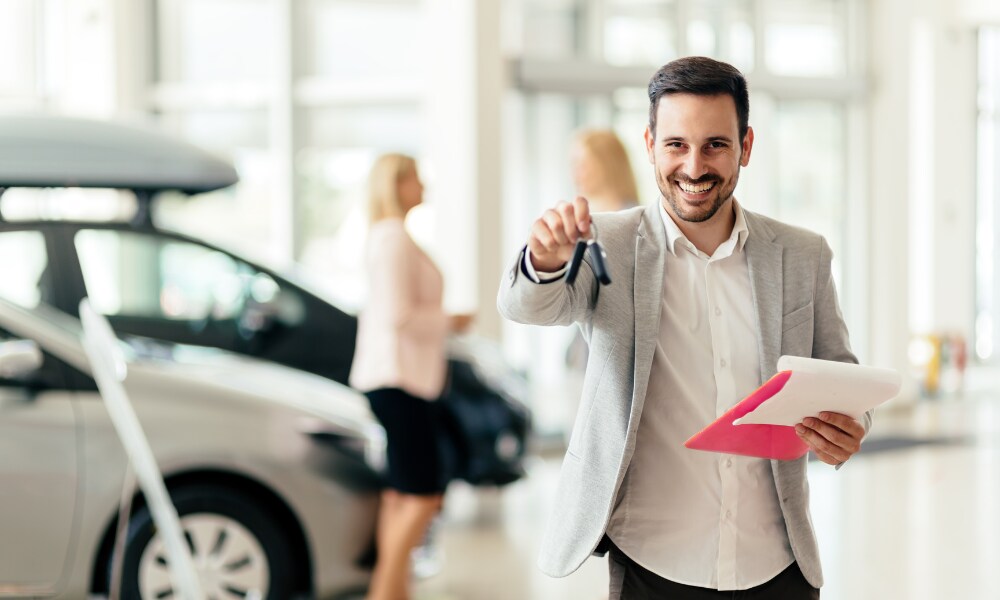 Financing options in Gainesville Man with clipboard and car keys