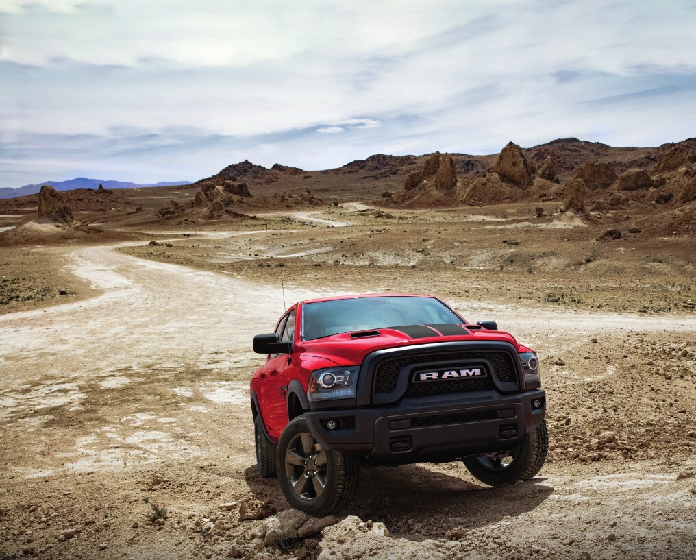 2022 Ram 1500 Red.PNG red Ram 1500 truck bouldering on desert rocks