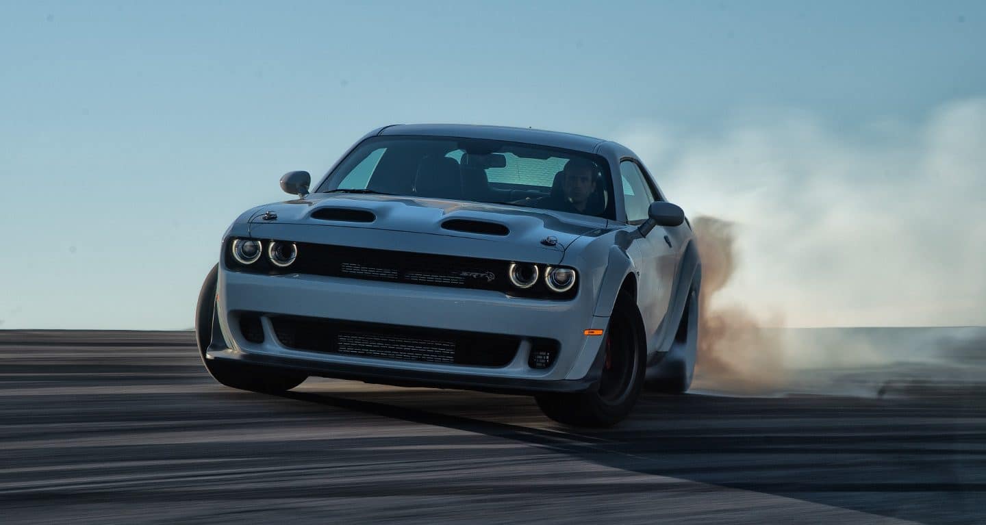 white Dodge Charger skidding across the track