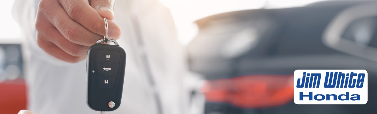 Your%20Top-Rated%20Auto%20Dealer%20Near%20Toledo%20%E2%80%93%20Jim%20White%20Honda1.png Warm and welcoming Honda sales consultant assisting customers inside the showroom
