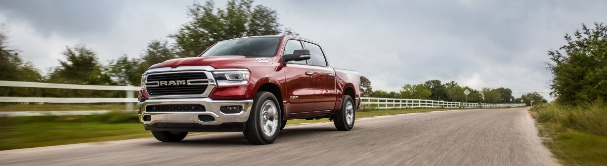 2019-RAM-1500-BigHorn-CrewCab-Truck-L12 (1).jpg New Ram 1500 driving next to a ranch