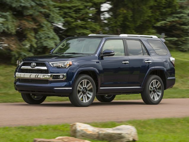 Dark Blue 2022 Toyota 4Runner on road with green trees behind