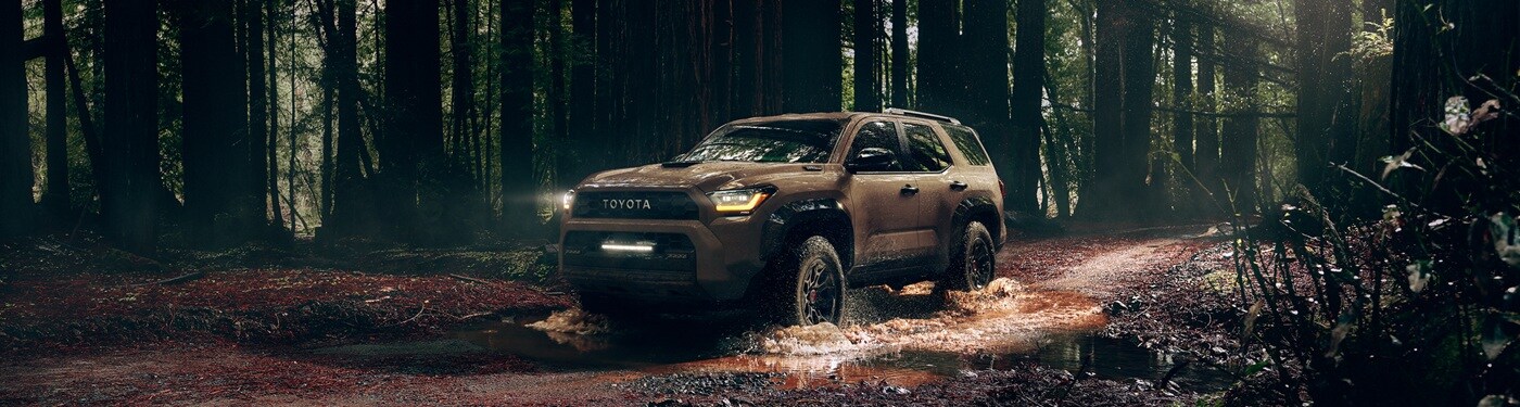 Toyota 4Runner Brown Toyota 4Runner TRD Pro driving thru mud in the forest