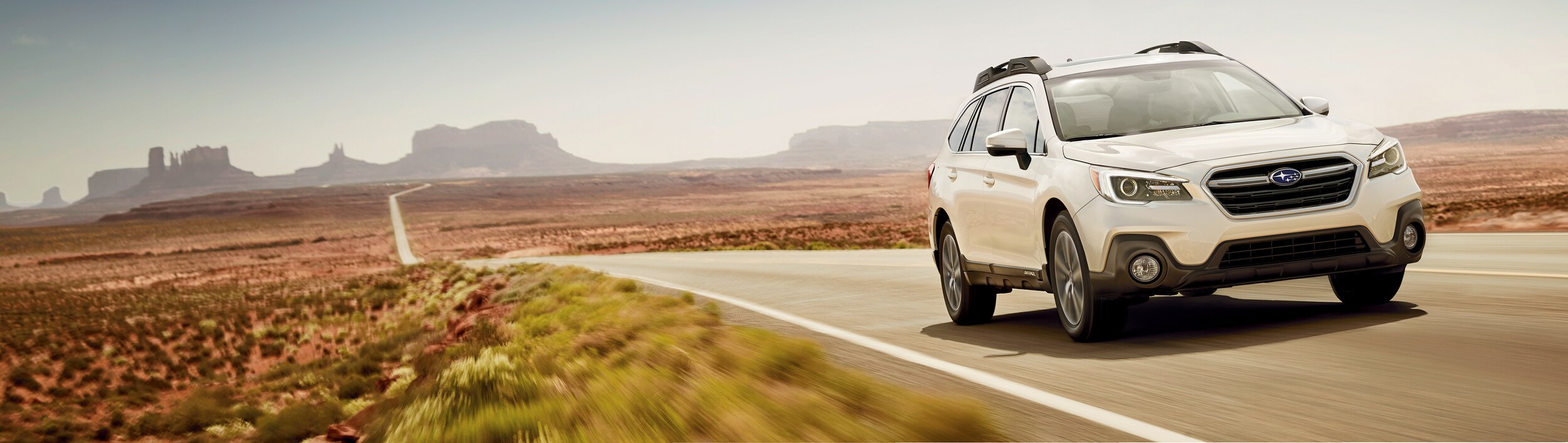 Subaru Outback driving through desert
