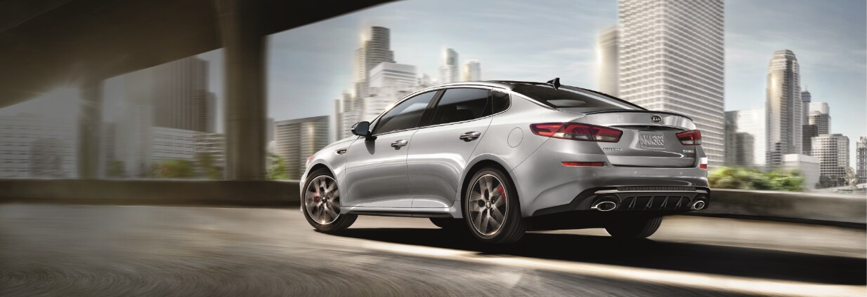Silver Kia Optima rear driver side view