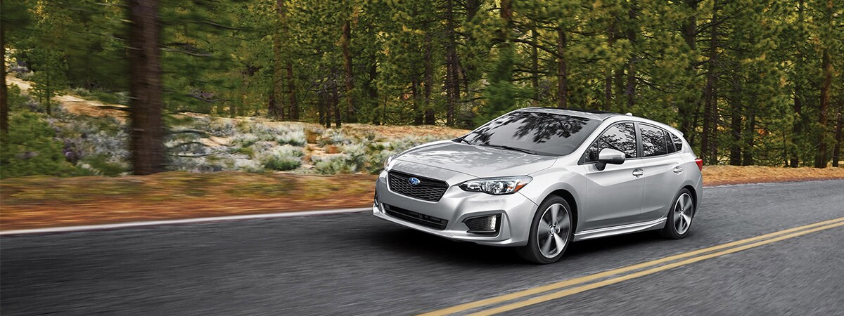 Subaru Impreza driving through woods