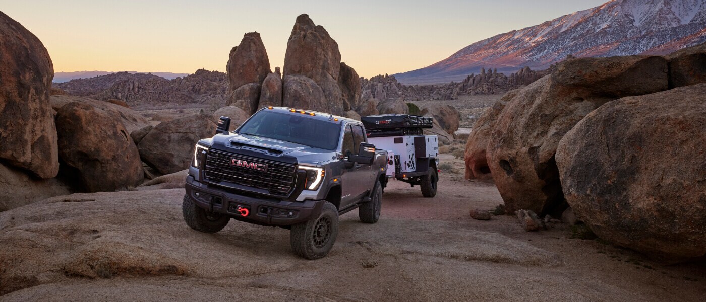 2025 GMC Sierra 2500 Exterior On Rocks With A Camper