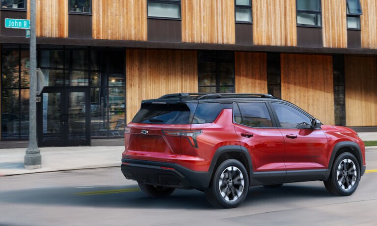 2025 Chevy Equinox driving past wooden office building