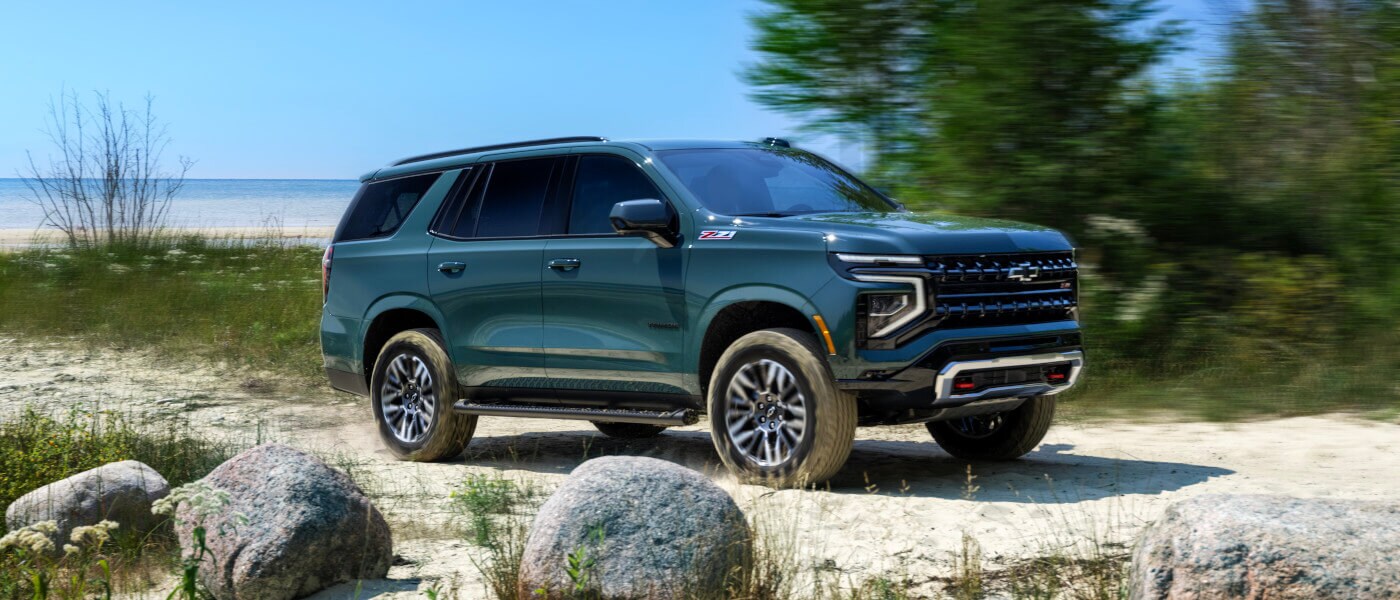 2025 Chevy Tahoe offroading by a lake