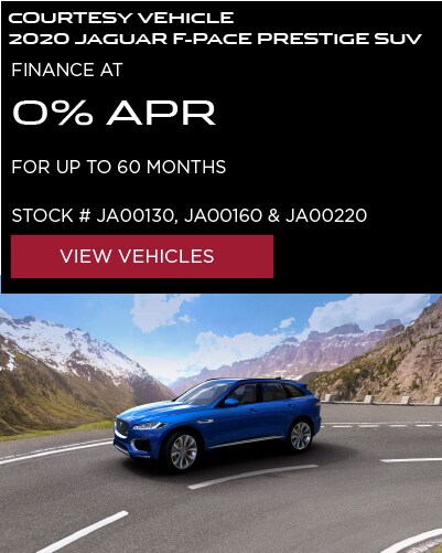 COURTESY VEHICLE 2020 JAGUAR F-PACE PRESTIGE SUV. FINANCE AT 0% APR FOR UP TO 60 MONTHS. AVAILABLE ON STOCK NUMBERS JA00130, JA00160 & JA00220. VIEW VEHICLES. BLUE JAGUAR F-PACE DRIVING DOWN ROAD NEAR MOUNTAIN RANGE.