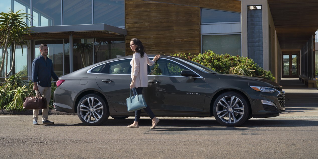 Couple walking around their 2025 Chevy Malibu Couple walking around their 2025 Chevy Malibu