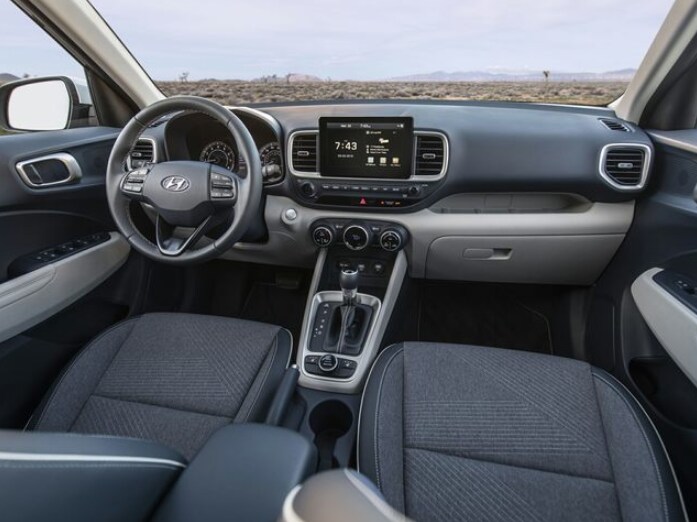 2024 Hyundai Venue interior.png grey Hyundai Venue interior front seats, dashboard, and infotainment center