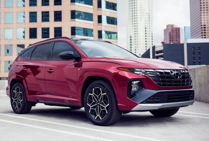 2024 Hyundai Tucson Hybrid N Line.png red Hyundai Tucson Hybrid SUV N Line parked on a rooftop lot