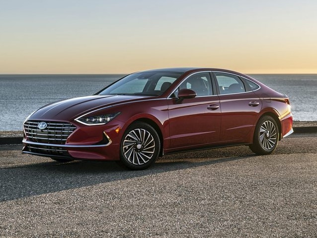 2022-Hyundai-Sonata-Hybrid-Sedan.PNG red Hyundai Sonata hybrid sedan parked on a lot near the water