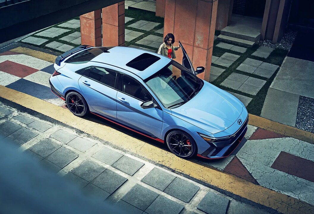 Woman opening the door to her 2025 Hyundai Elantra N