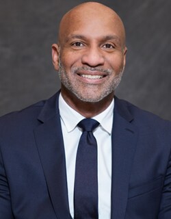 Mark Haynes, the GM of Lexus of Valencia, smiles while looking at a camera