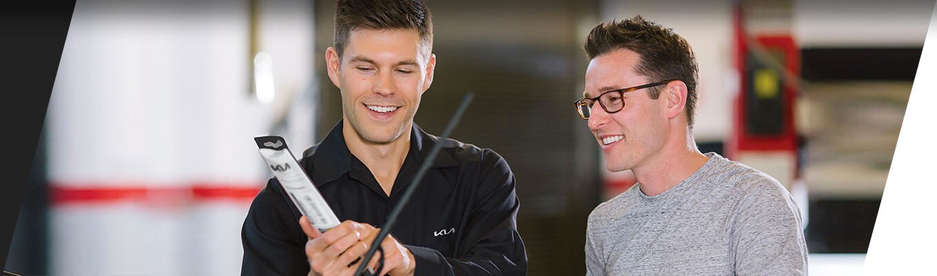 technician showing customer list of Kia parts technician showing customer list of Kia parts