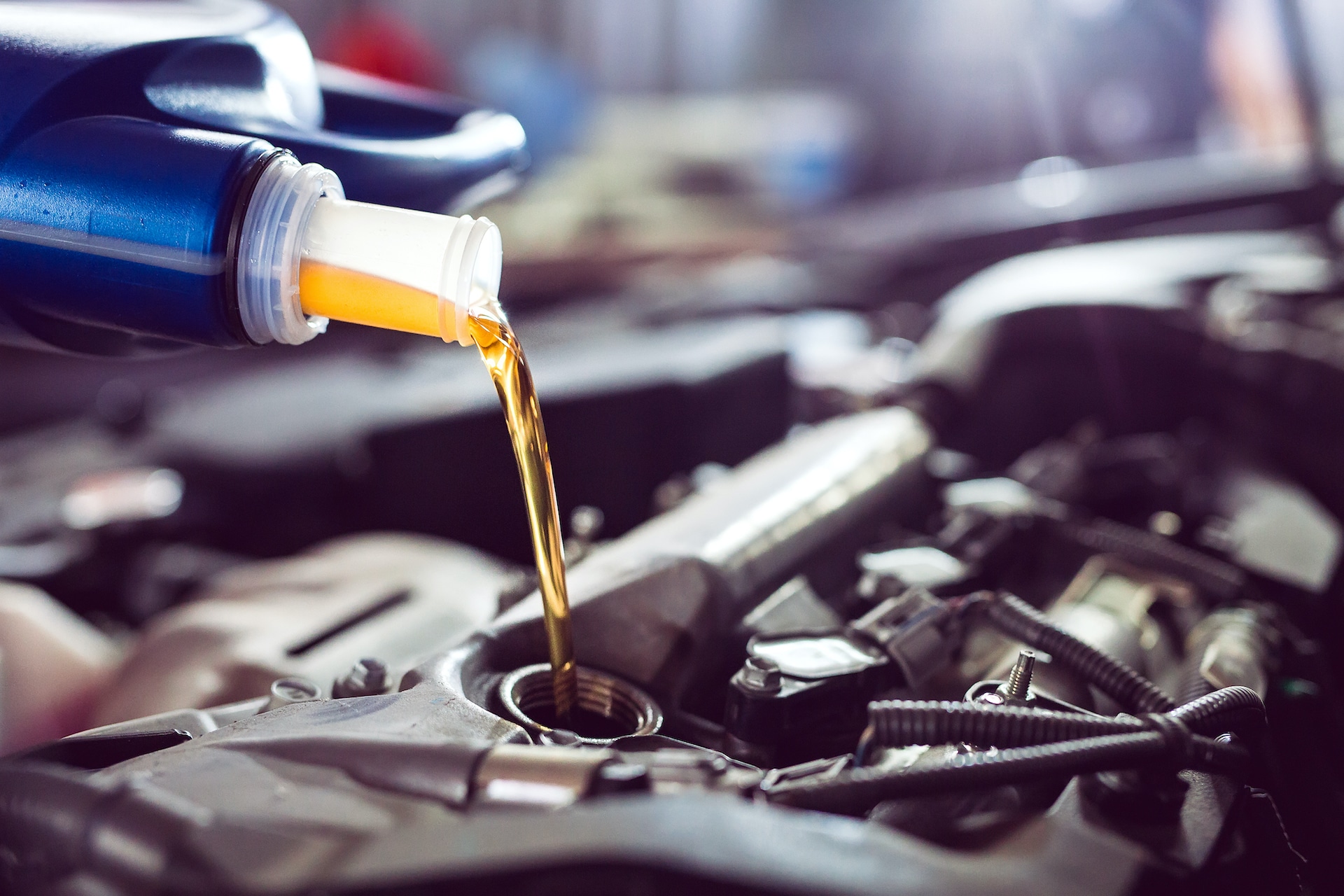 Kia Oil Change Benefits at Kia of New Bern | Oil being poured into engine