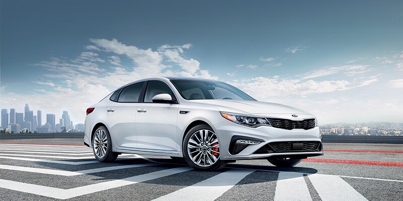 White Kia Optima on road