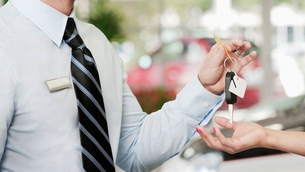 car_loans Guy Hands Keys to Happy New Car Owner