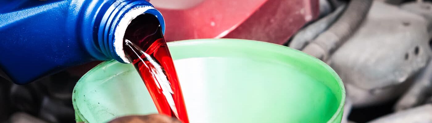Pouring transmission fluid into a funnel