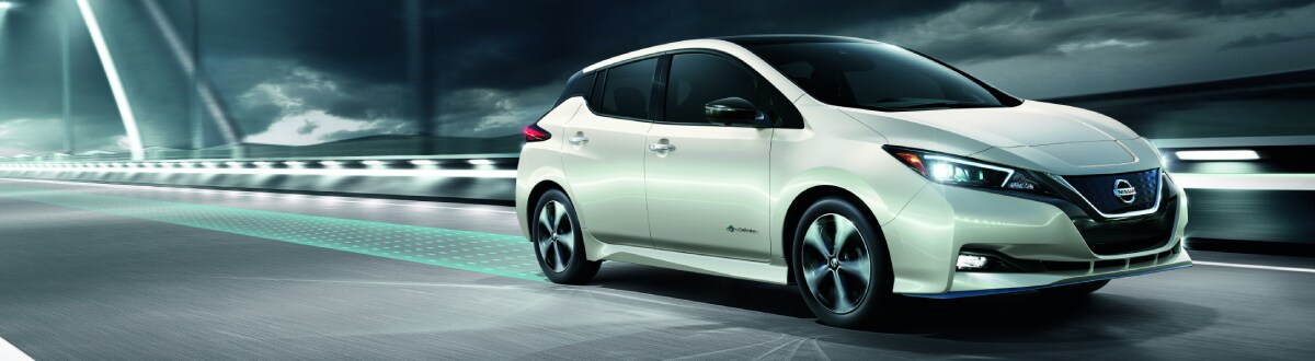 19TDI_LEAFb002_master-rev-1.jpg Nissan Leaf driving on a city street at night