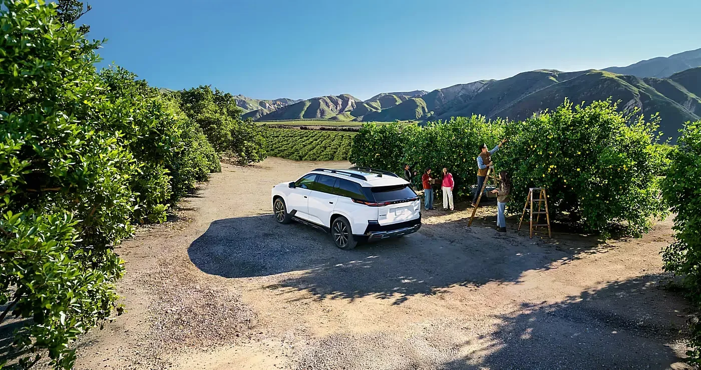 Rear three-quarter view of the white Getaway in an orchard.